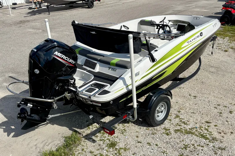 The Image of 2024 Tahoe T16 boat with Mercury engine on trailer, parked on gravel. - 0