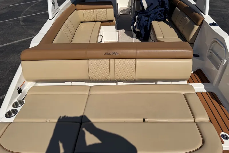 Slide: The Image of 2015 Sea Ray 270 Sundeck boat interior with tan leather seating and cup holders. - 17