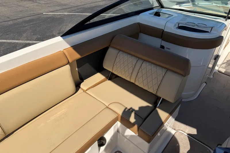 Slide: The Image of 2015 Sea Ray 270 Sundeck interior with tan leather seating and modern design. - 15