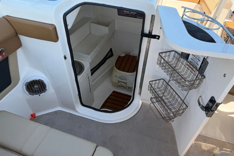 Slide: The Image of 2015 Sea Ray 270 Sundeck interior with storage and seating area. - 16