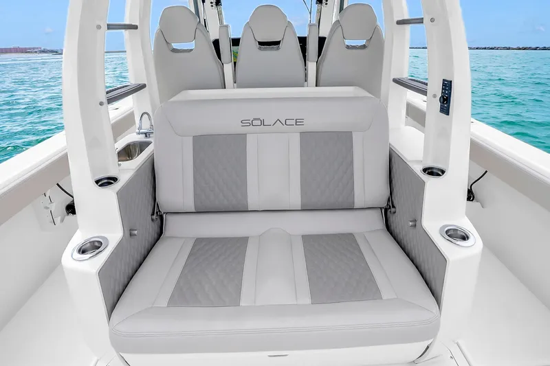 Slide: The Image of Luxury seating on 2025 Solace 37CS boat, featuring elegant design and ocean backdrop. - 54