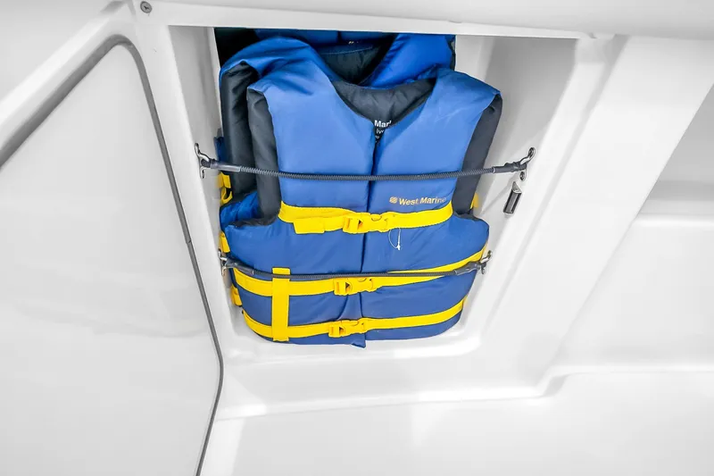 Slide: The Image of Blue and yellow life jackets stored in a compartment on a 2025 Solace 37CS boat. - 66