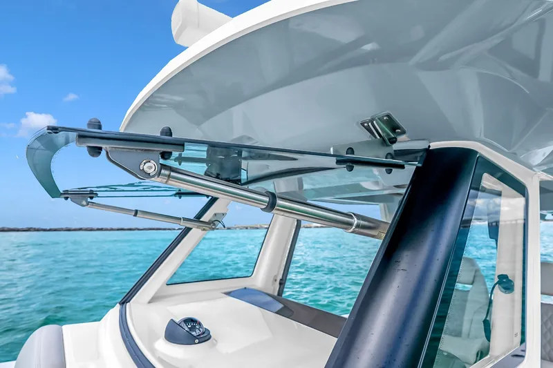 Slide: The Image of 2025 Solace 37CS boat with advanced windshield design on a clear blue sea. - 95