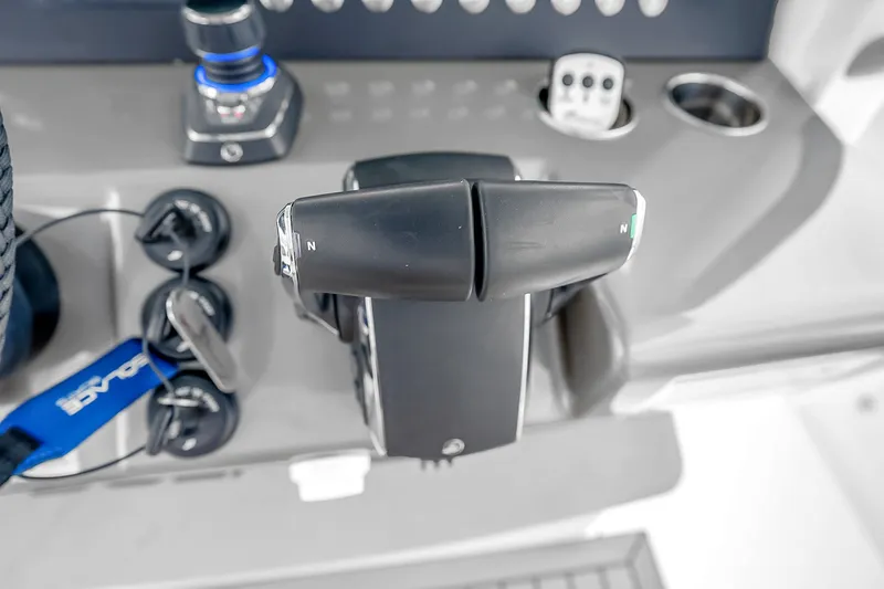 Slide: The Image of 2025 Solace 37CS boat controls with throttle levers and key switches. - 51