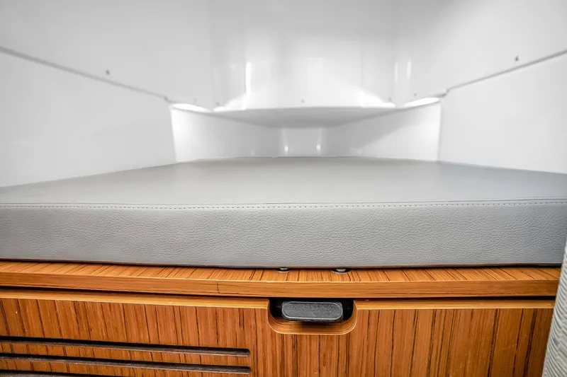 Slide: The Image of Interior cabin of 2025 Solace 37CS with sleek wooden storage and cushioned bed. - 34