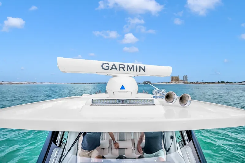Slide: The Image of 2025 Solace 37CS boat with Garmin radar, cruising on clear blue waters. - 92