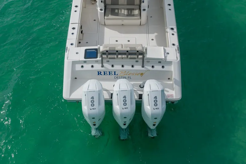 Slide: The Image of 2025 Solace 37CS boat with triple 400 V10 engines on turquoise water. - 23
