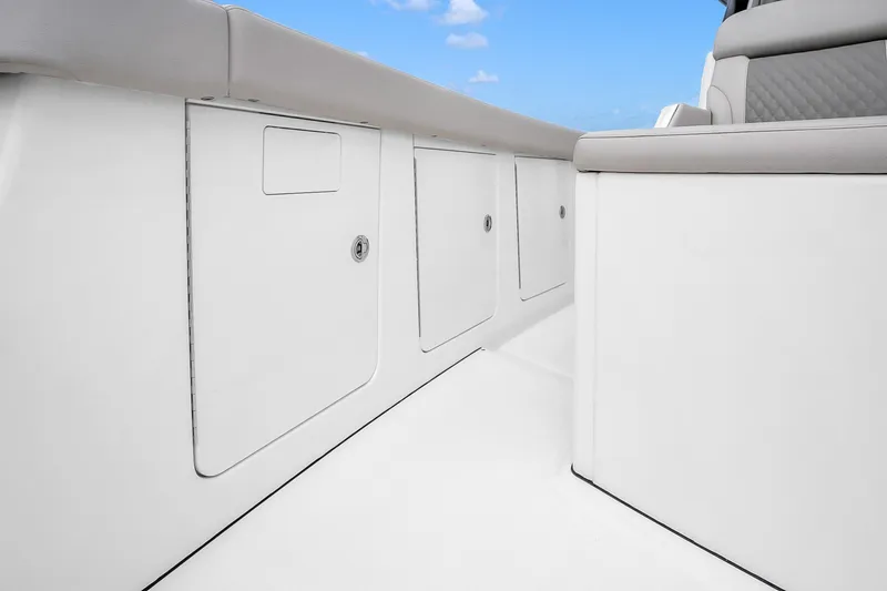 Slide: The Image of 2025 Solace 37CS boat interior with sleek white storage compartments and cushioned seating. - 87