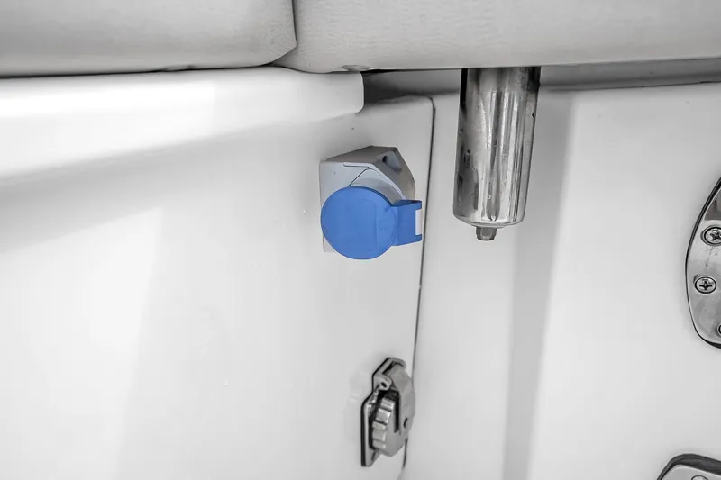 Slide: The Image of Power outlet on 2025 Solace 37CS boat, featuring a blue cover and stainless steel fixture. - 85