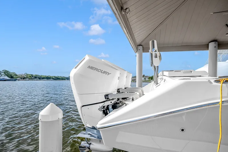 Slide: The Image of 2025 Solace 37CS boat with Mercury outboard engine docked by the water. - 103