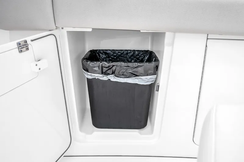 Slide: The Image of Built-in trash bin on 2025 Solace 37CS boat, featuring sleek white interior design. - 78