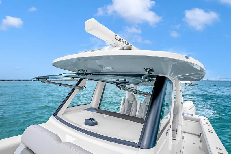 Slide: The Image of 2025 Solace 37CS boat on clear blue water, featuring advanced Garmin technology. - 94