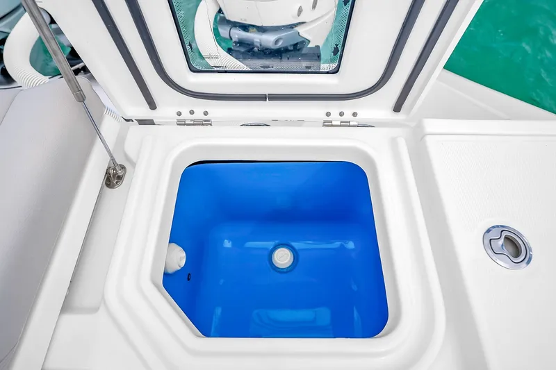 Slide: The Image of Open storage compartment on 2025 Solace 37CS boat, featuring a blue interior. - 63