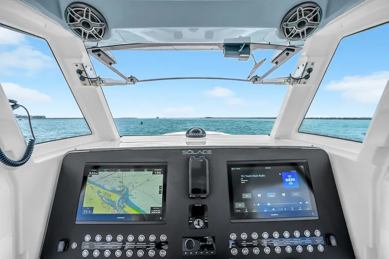 Slide: The Image of 2025 Solace 37CS boat dashboard with dual navigation screens, ocean view. - 47
