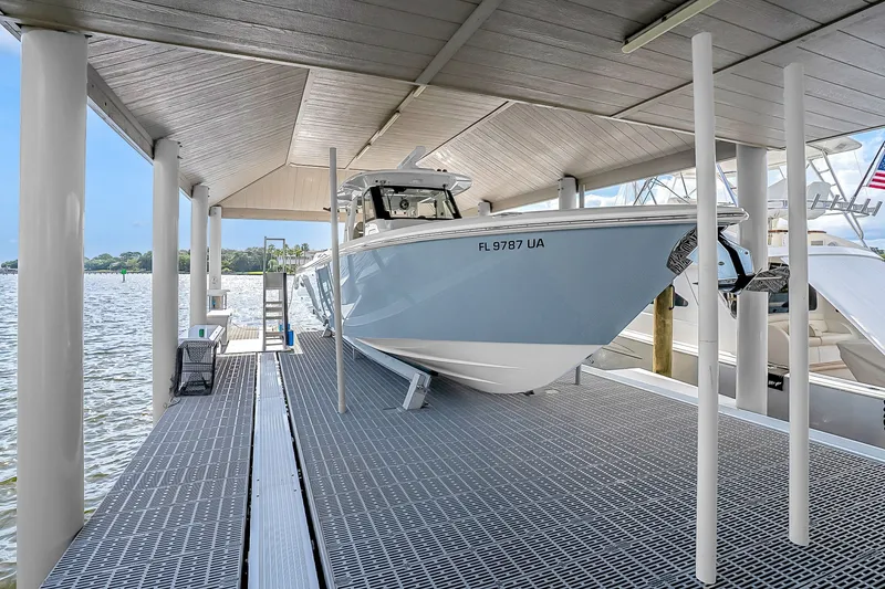 Slide: The Image of 2025 Solace 37CS boat docked under covered marina on a sunny day. - 105