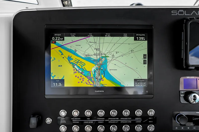 Slide: The Image of Garmin navigation display on 2025 Solace 37CS boat dashboard, showing nautical map and controls. - 48