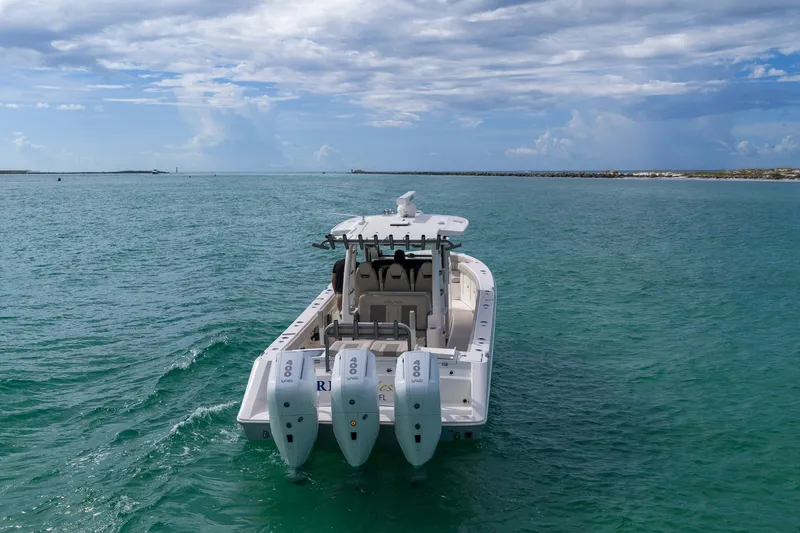 Slide: The Image of 2025 Solace 37CS boat with triple engines cruising on open water. - 27