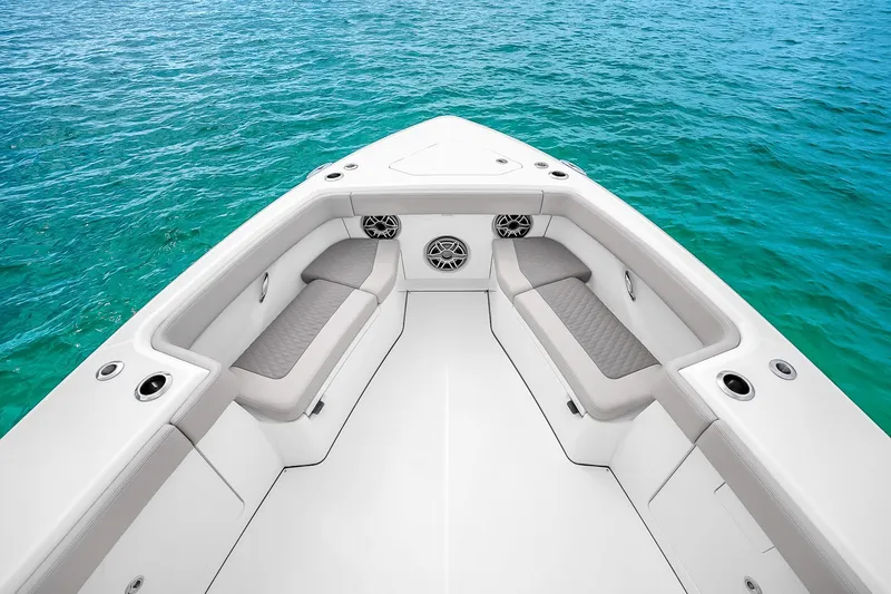 Slide: The Image of Bow seating area of 2025 Solace 37CS boat on clear blue water. - 96