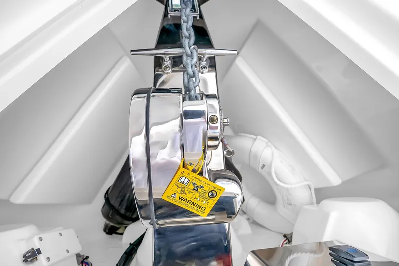 Slide: The Image of Anchor chain mechanism on 2025 Solace 37CS boat, featuring a warning label. - 98
