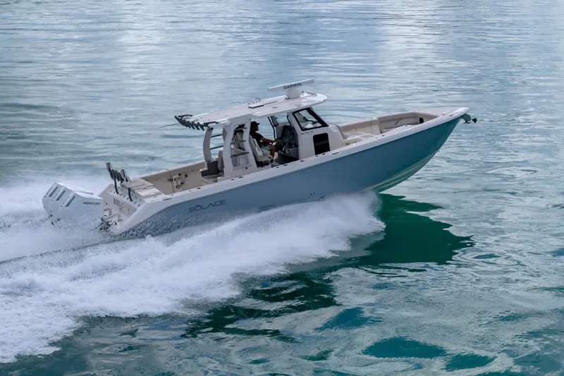 The Image of 2025 Solace 37CS boat cruising on clear blue water. - 1