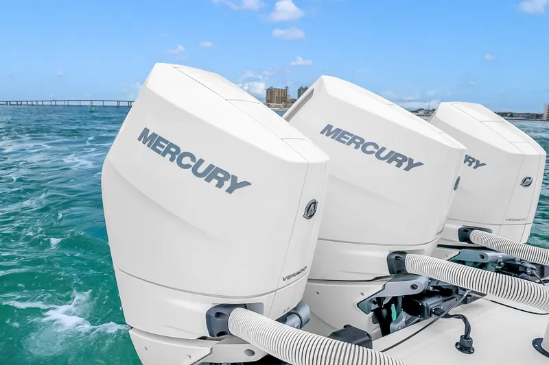 Slide: The Image of Triple Mercury outboard engines on a 2025 Solace 37CS boat in open water. - 72