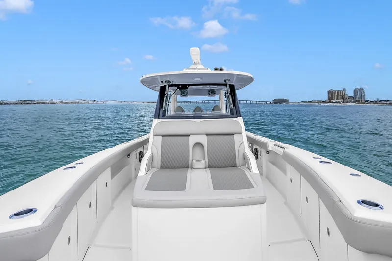 Slide: The Image of 2025 Solace 37CS boat on open water, showcasing sleek design and spacious seating. - 99