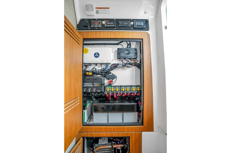 Slide: The Image of Electrical panel inside 2025 Solace 37CS boat, featuring advanced wiring and battery systems. - 40