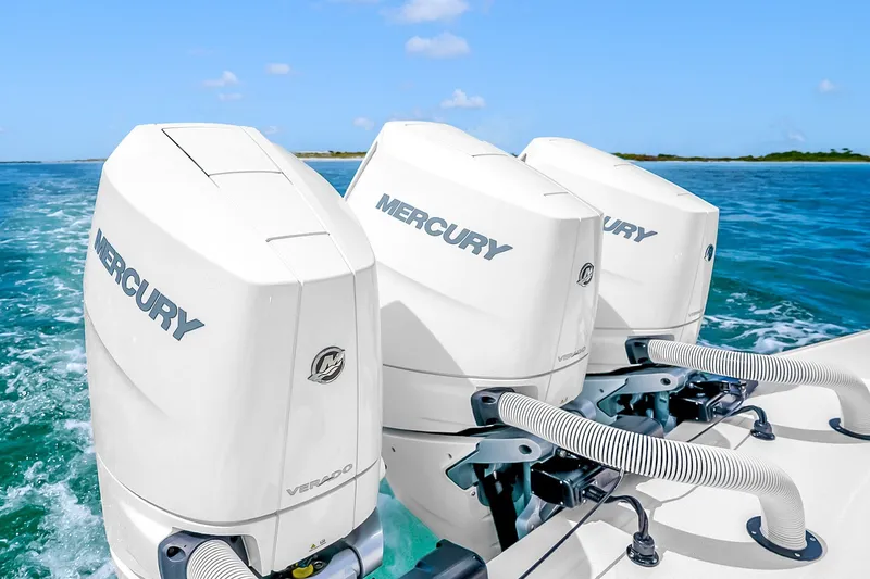 Slide: The Image of Triple Mercury outboard engines on a 2025 Solace 37CS boat in clear blue waters. - 71