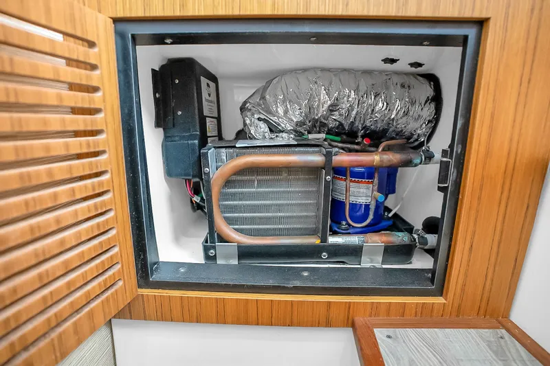 Slide: The Image of 2025 Solace 37CS boat air conditioning unit in wooden cabinet. - 38