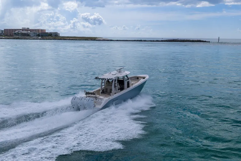 Slide: The Image of 2025 Solace 37CS boat cruising on open water under a cloudy sky. - 17