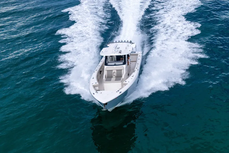 Slide: The Image of 2025 Solace 37CS boat cruising on open water, creating a dynamic wake. - 18