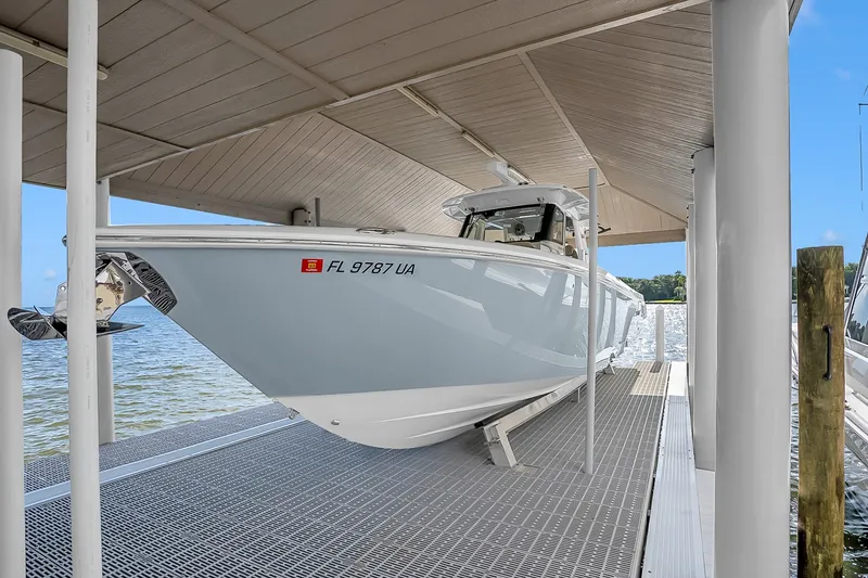 Slide: The Image of 2025 Solace 37CS boat docked under a covered slip, side view. - 104