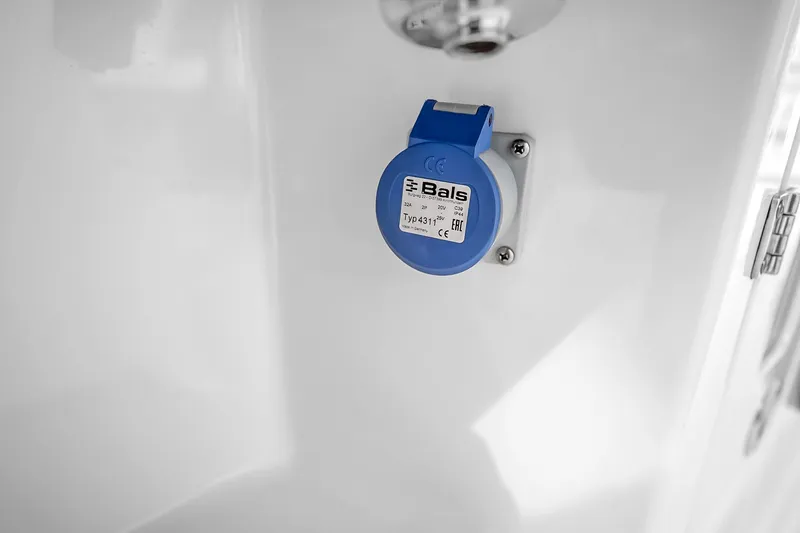 Slide: The Image of Blue electrical socket on Solace 37CS 2025 model, mounted on a white surface. - 79