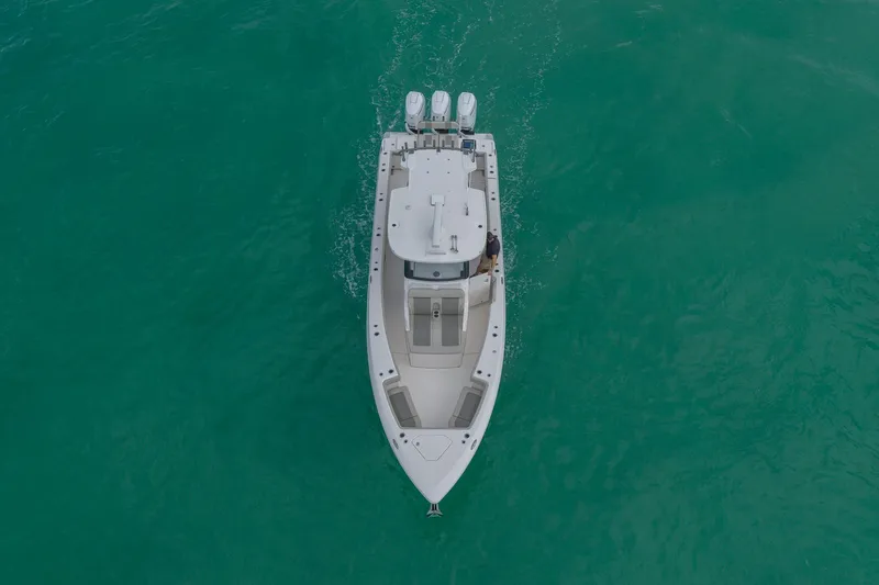Slide: The Image of Aerial view of 2025 Solace 37CS boat cruising on turquoise water. - 31