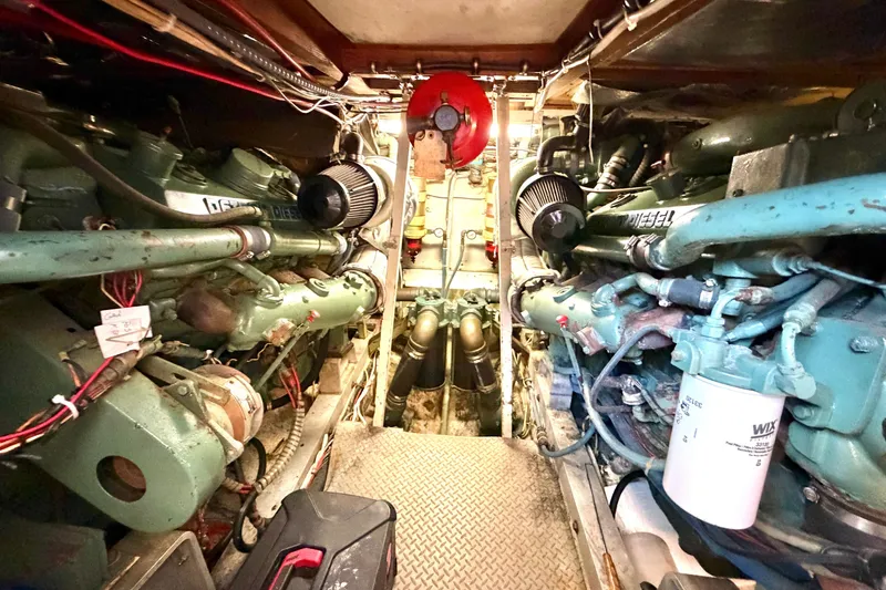Slide: The Image of Engine room of a 1974 Bertram 46 Convertible yacht, showcasing dual diesel engines. - 27