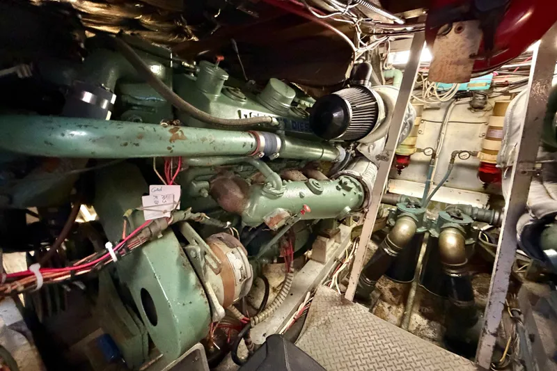 Slide: The Image of Engine room of a 1974 Bertram 46 Convertible boat, showcasing mechanical components. - 29