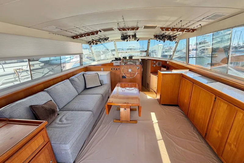 Slide: The Image of Interior of a 1974 Bertram 46 Convertible yacht with wooden cabinetry and a cozy seating area. - 14