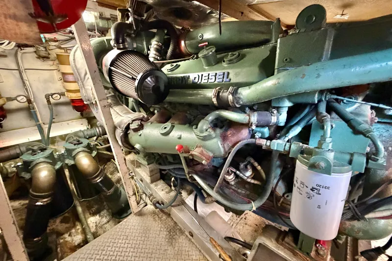 Slide: The Image of Engine room of a 1974 Bertram 46 Convertible boat, featuring a diesel engine. - 31