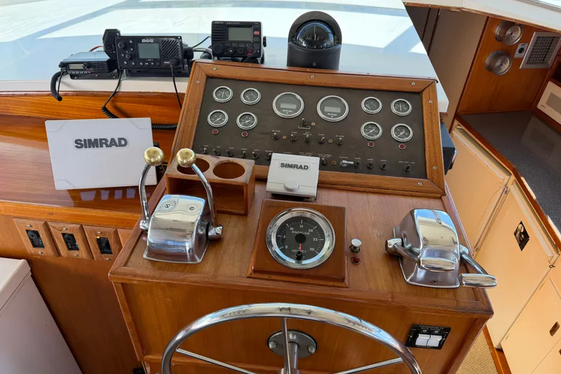 Slide: The Image of 1974 Bertram 46 Convertible helm with Simrad navigation, gauges, and controls. - 20