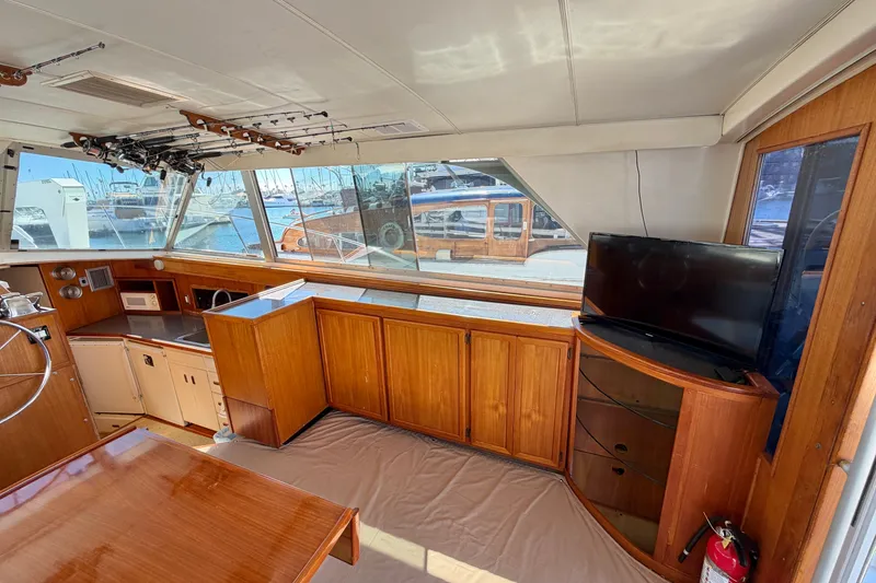Slide: The Image of Interior of a 1974 Bertram 46 Convertible yacht with wood cabinetry and a TV. - 15