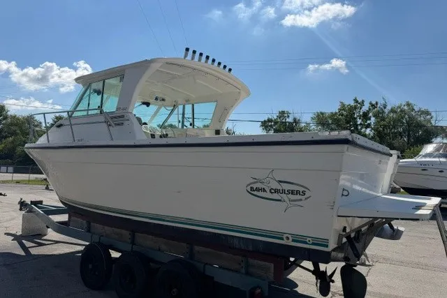 Slide: The Image of 2003 Baha Cruisers 277 GLE boat on trailer under clear blue sky. - 18