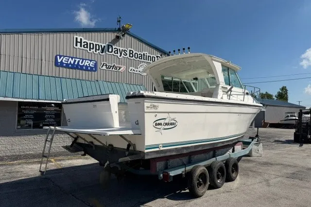 Slide: The Image of 2003 Baha Cruisers 277 GLE boat on trailer at Happy Days Boating, sunny day. - 19
