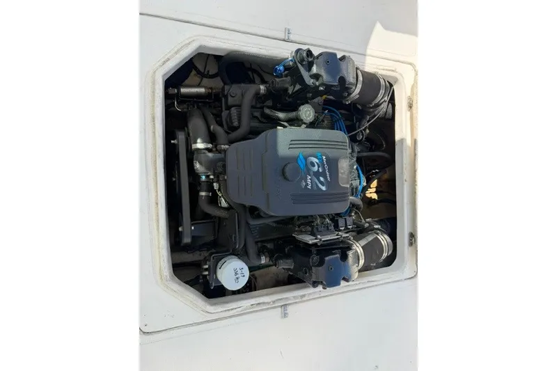 Slide: The Image of Engine compartment of a 2003 Baha Cruisers 277 GLE boat, showcasing the motor. - 16