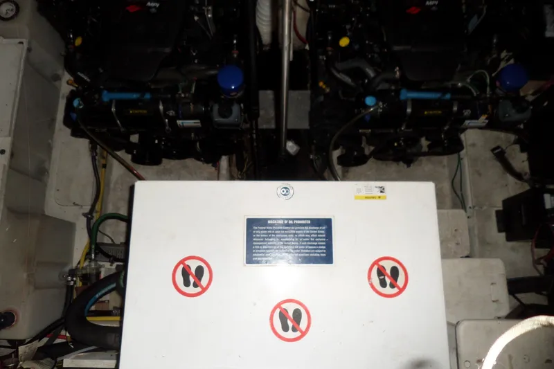 Slide: The Image of Engine room of 2008 Bayliner 320 Cruiser with visible machinery and safety signs. - 57