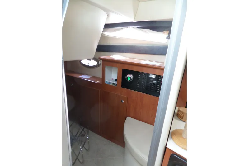 Slide: The Image of Interior of 2008 Bayliner 320 Cruiser with wood cabinetry and control panel. - 41