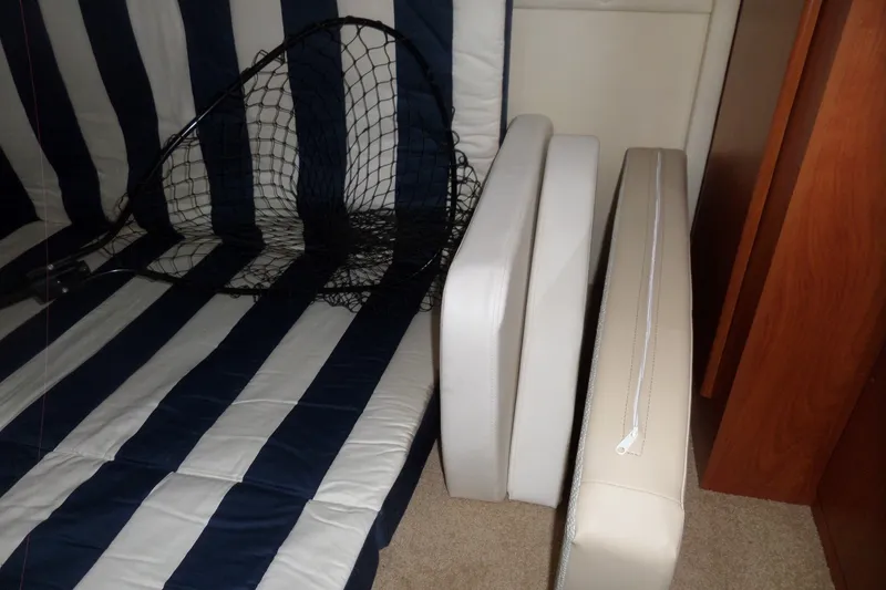 Slide: The Image of Interior of 2008 Bayliner 320 Cruiser with striped cushions and fishing net. - 44