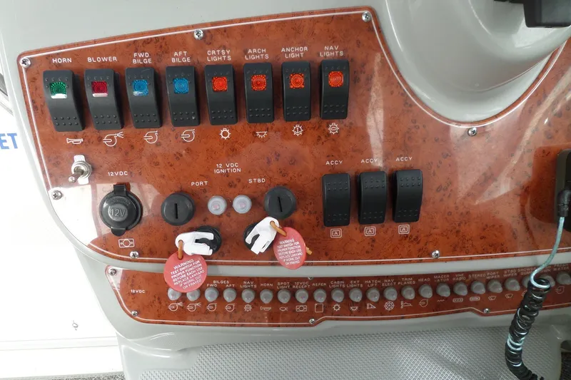 Slide: The Image of Control panel of a 2008 Bayliner 320 Cruiser with various switches and indicators. - 11