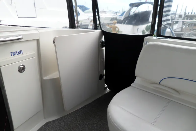 Slide: The Image of Interior of a 2008 Bayliner 320 Cruiser with seating and trash compartment. - 24