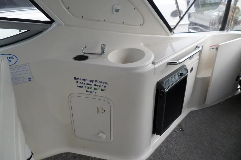 Slide: The Image of 2008 Bayliner 320 Cruiser interior with safety equipment storage and compact sink area. - 22