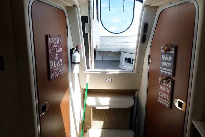 Slide: The Image of Interior of 2008 Bayliner 320 Cruiser with nautical-themed decor and signage. - 34